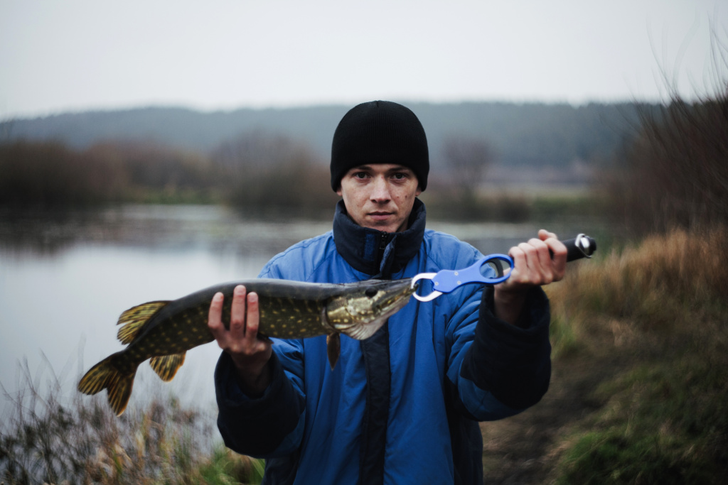 portrait-man-holding-pike-fish.jpg portrait-man-holding-pike-fish.jpg