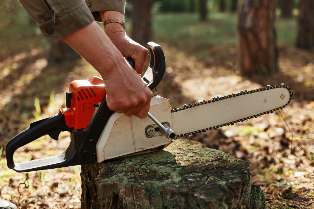 outdoor-shot-unknown-person-worker-fixing-chainsaw-before-after-deforestation.jpg outdoor-shot-unknown-person-worker-fixing-chainsaw-before-after-deforestation.jpg